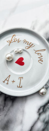 Personalized gold engraving on a trinket tray.