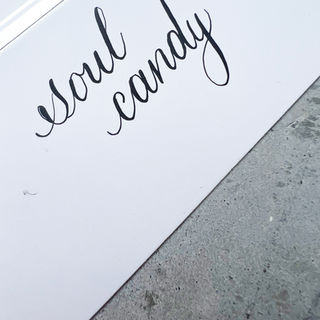 Toronto Calligrapher Engraver Live Event Ishaana M Cherian The Doodler Scribbler writes copperplate calligraphy on white card stock.