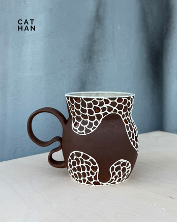 Brown ceramic mug with white detailing from theclaycorner
