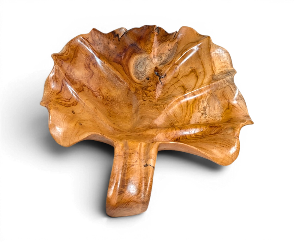 Hand carved teakwood leaf serving platter from Bali with natural golden wood grain