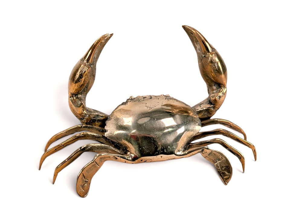 Freestanding handmade brass crab figurine with two claws raised overhead