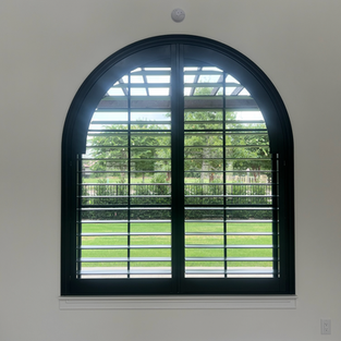 black real wood shutter on large arched window