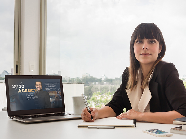Optometrist woman displaying 20/20 Agency Group on Laptop