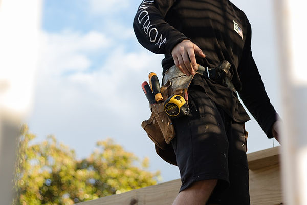 adu contractor with toolbelt on