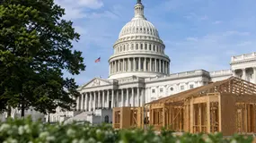 white house with a wooden house built in front of it