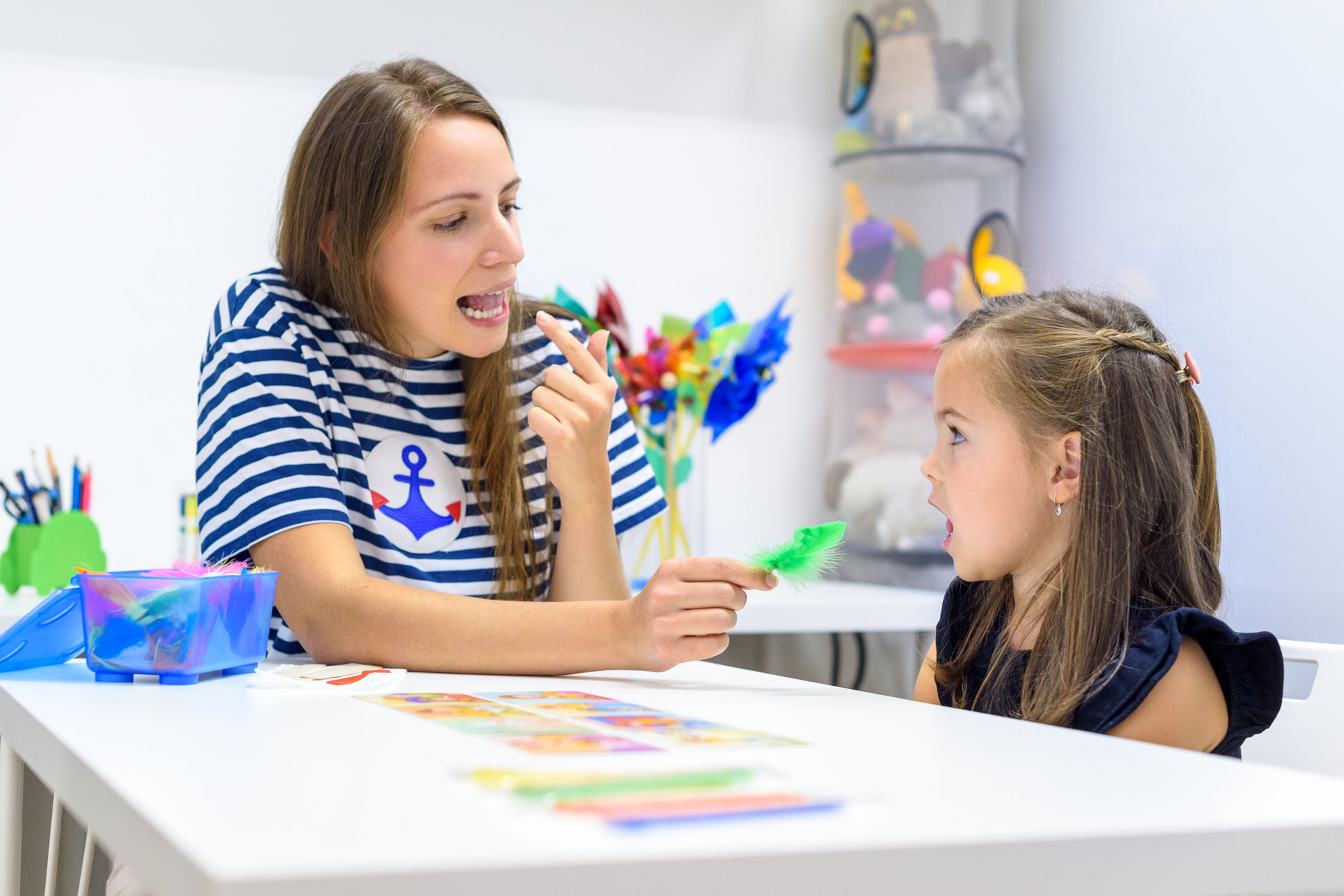 Speech Language Pathologist modeling tongue placement for preschool student