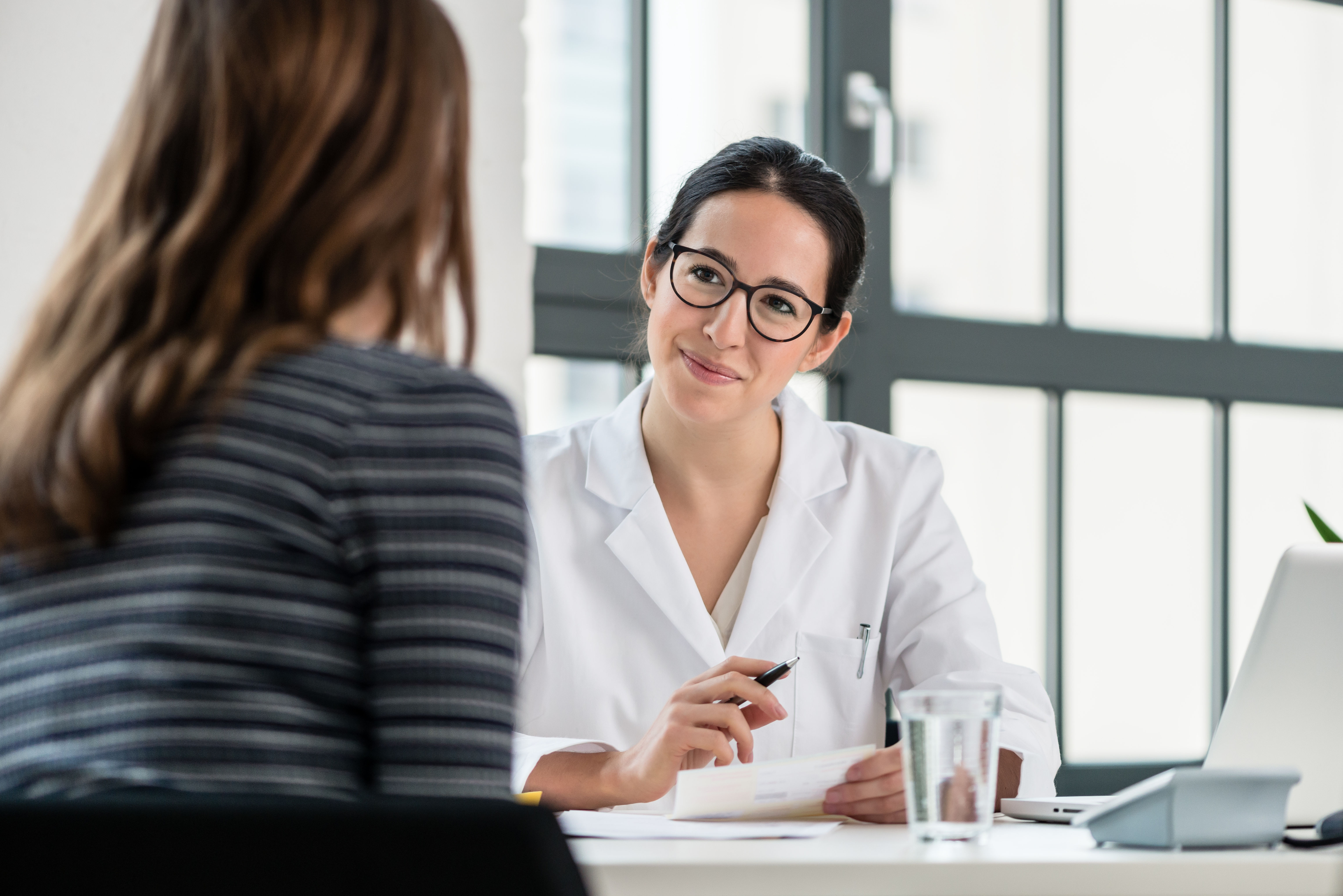 Speech Language Pathologist consulting with patient about speech and language strengths and weaknesses