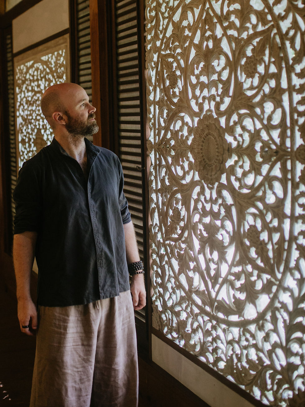 Man observing intricate shadow pattern