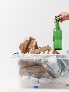 cropped-shot-of-woman-putting-glass-bott