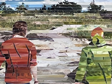 Two people walking up the beach