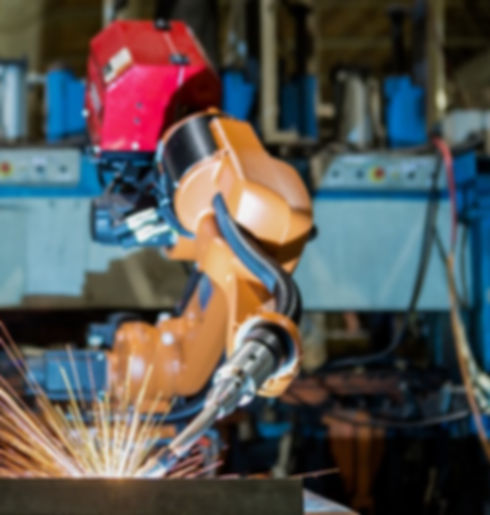 Industrial Robot Welding Operation - An industrial robot performing precise welding tasks within an industrial setting. This image captures the automated precision of robotic welding technology as the robot meticulously joins metal components. The bright arcs of light showcase the controlled and accurate nature of the welding process, illustrating the efficiency and reliability of industrial robotics in manufacturing and metalworking.