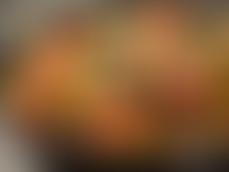 Bowl of Tex-Mex pasta salad with ground beef, black beans, cherry tomatoes, and green peppers mixed into spiral pasta.