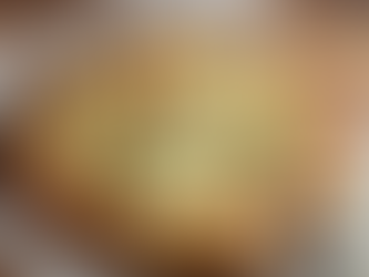 Golden cheesy garlic flatbread baked on parchment paper.