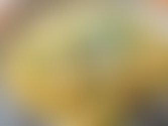 Bowl of creamy cacio e pepe pasta topped with freshly cracked black pepper and grated parmesan.