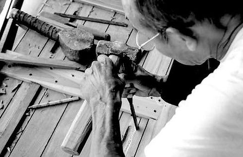 Worker-working-on-a-Recycled-Teak-Table.jpg
