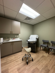 An exam room at Haven Women's Health in Cary, NC, equipped with medical essentials, ample seating, and ultrasound equipment