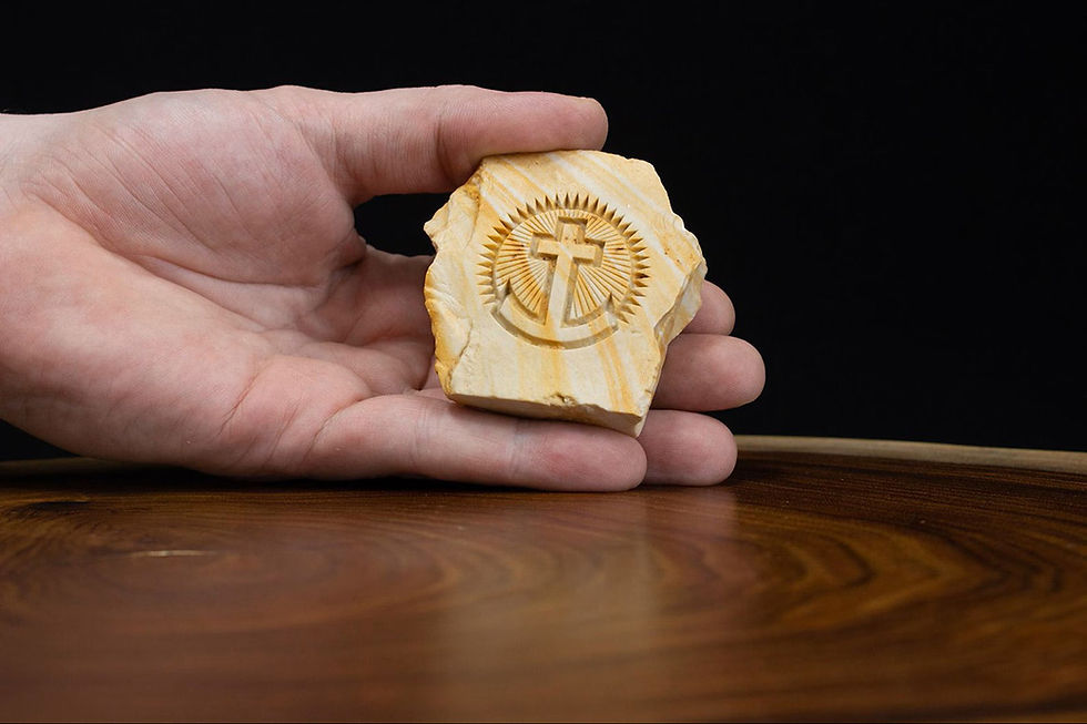 Thumbnail: Small Anchor Cross stone held in hand for scale