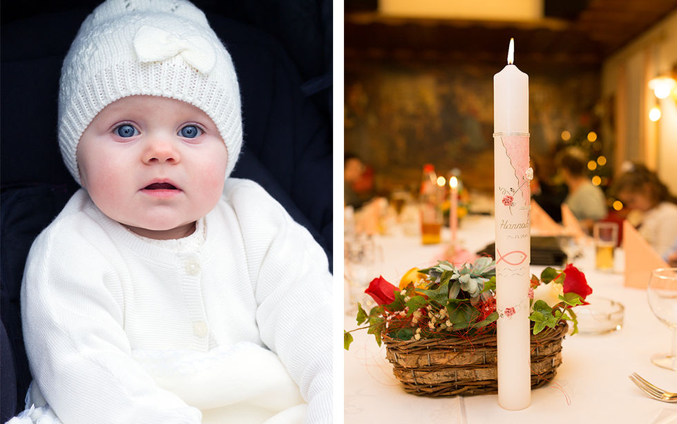 Hübsches Taufkind mit Haube, daneben eine Taufkerze
