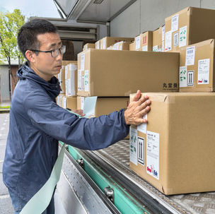 Boxed koi are loaded onto a lorry for shipping