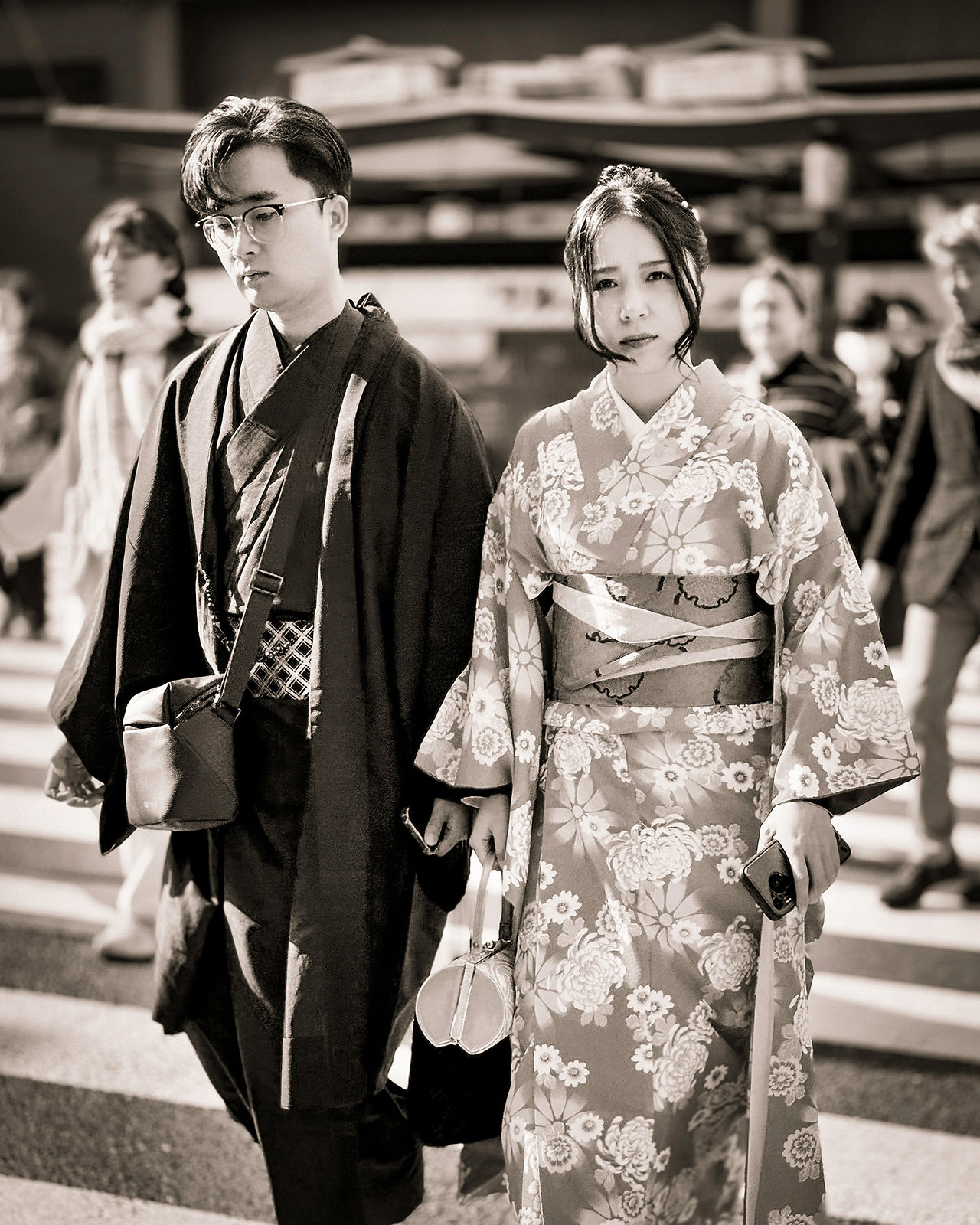 A young couple in Kimono's on the crowded streets of Kyoto