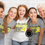 Thumbnail: Group of Various Women of All Ages Smiling with White or Gray I Wear Yellow to Promote Sarcoma Bone Cancer Awareness Shirts