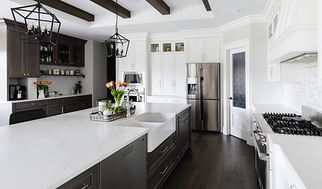 The white countertop on the kitchen island and brown cabinets 