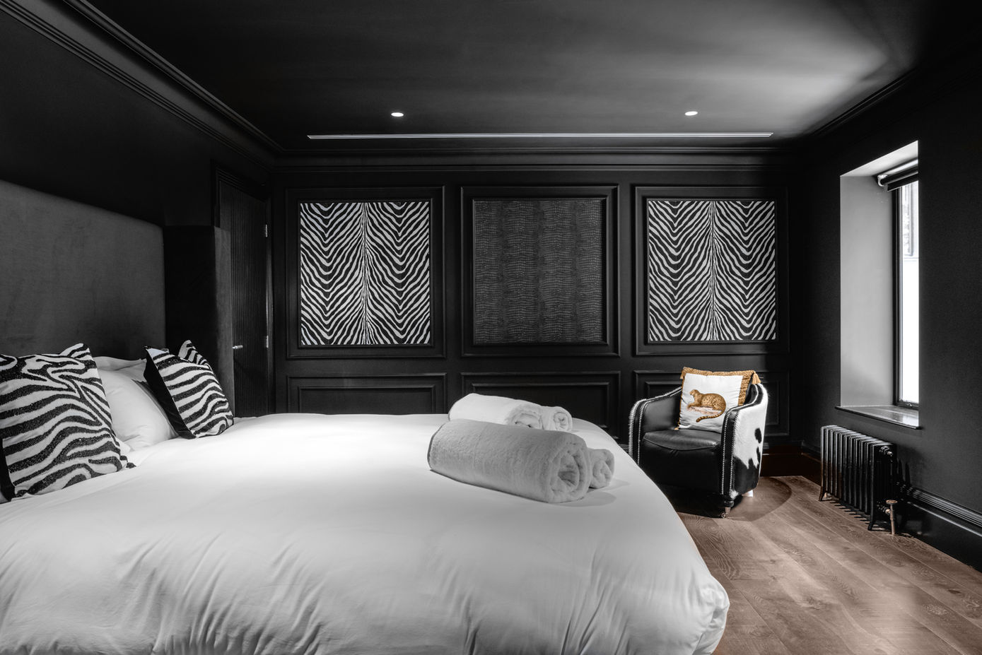 Stylish bedroom with dark walls and zebra print accents