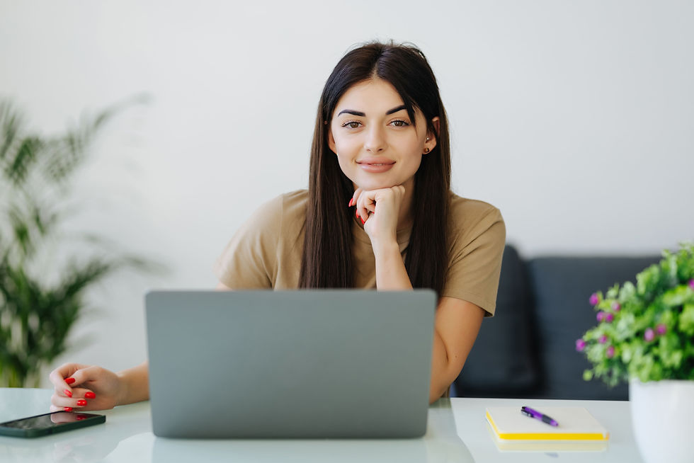 smiling-young-woman-with-laptop-home-office.jpg