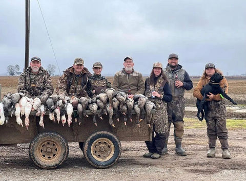Male and Female Hunter guests of Grandview Acres Lodge pose with geese