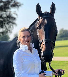 Ginny Howe stood next to a horse and smiling