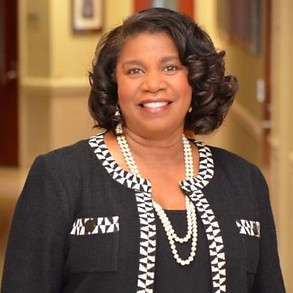 Dr. Marcia J. Millet standing in an academic hallway