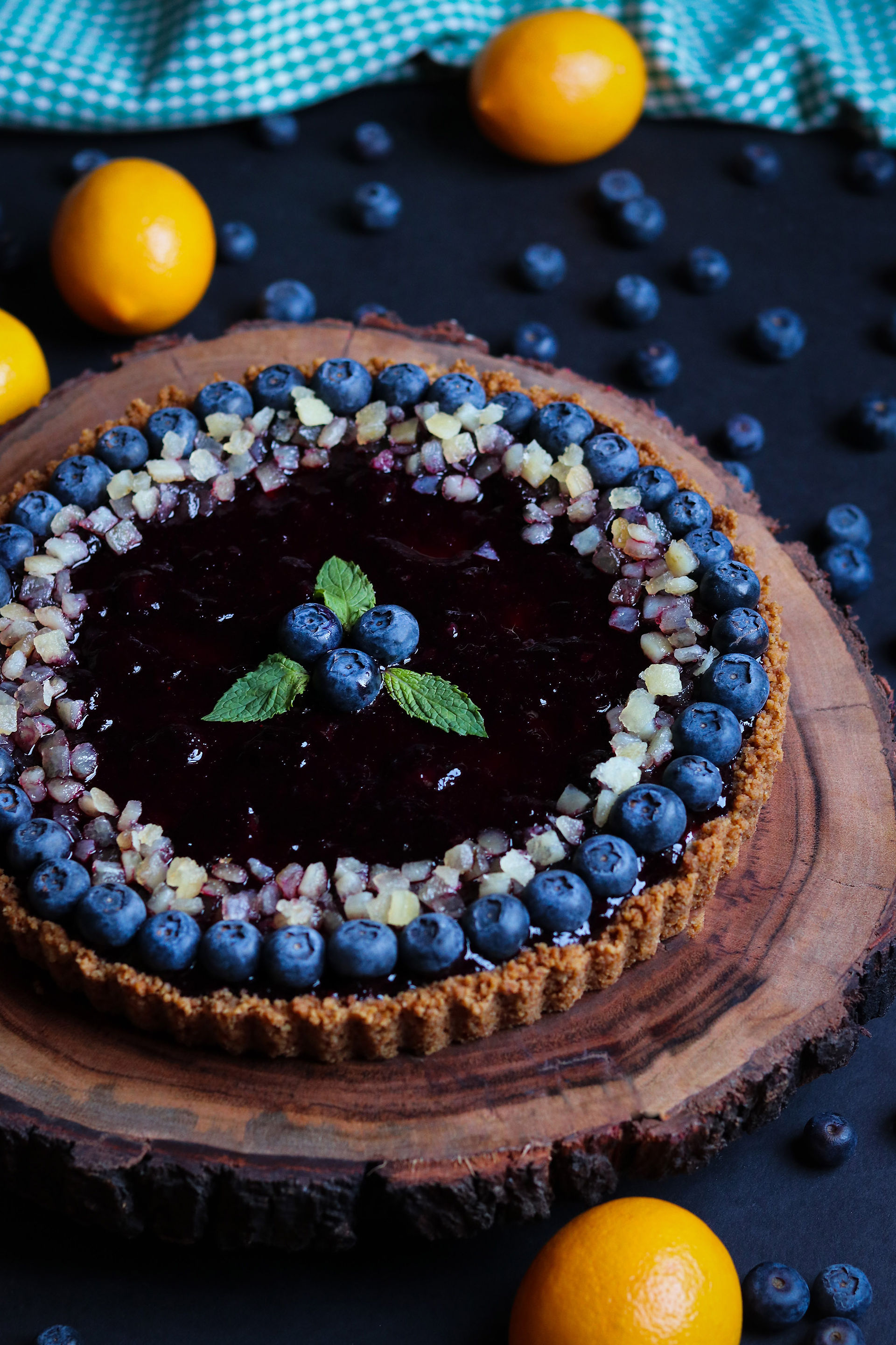 Lemon blueberry ricotta cheesecake tart with lemon snack crust and candied lemon peel