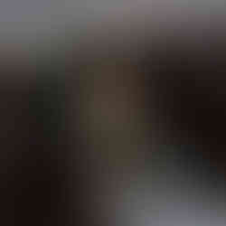 Wide view of latino coffee shop bar with customer holding two take away coffees.