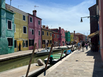 6773 - Burano is a picturesque island in the Venetian Lagoon known for its brightly painted houses, traditional lace-making, and charming canals. Located about 45 minutes from Venice, it is a popular day-trip destination, often considered one of the world's most colourful places and a haven for photographers. 