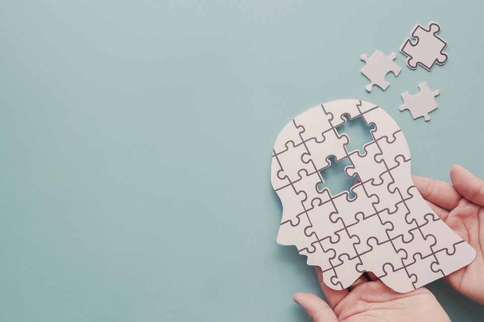 Hands holding brain with puzzle paper cutout, autism, memory loss, dementia, epilepsy and