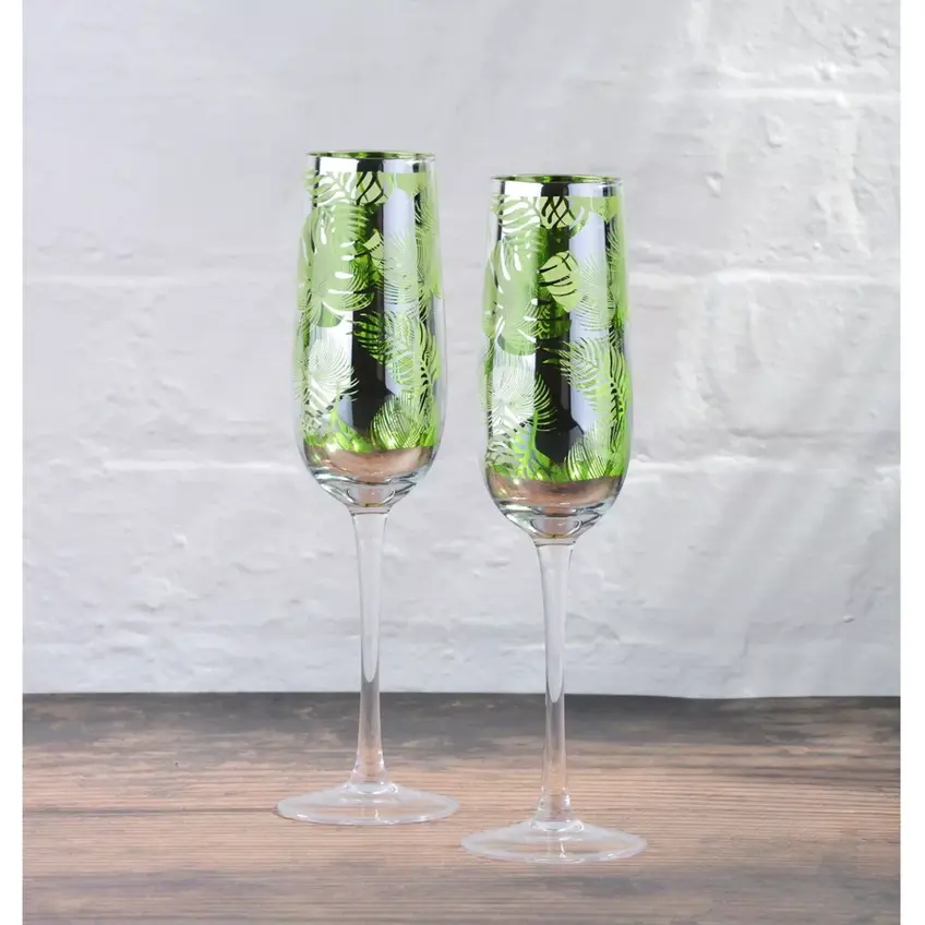 Set aus 2 Champagnerfloeten mit tropischen Blaettern