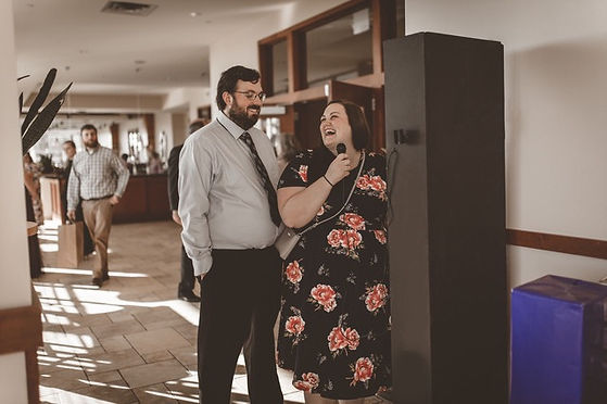 Couple laughing at wedding while recording video guestbook message at Pinstripes in Edina, Minnesota