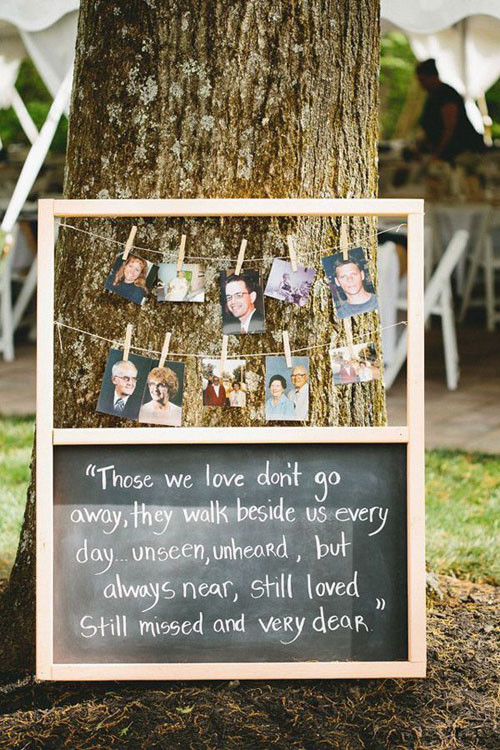 memory board at wedding with photos of departed loved ones attached with clothespins