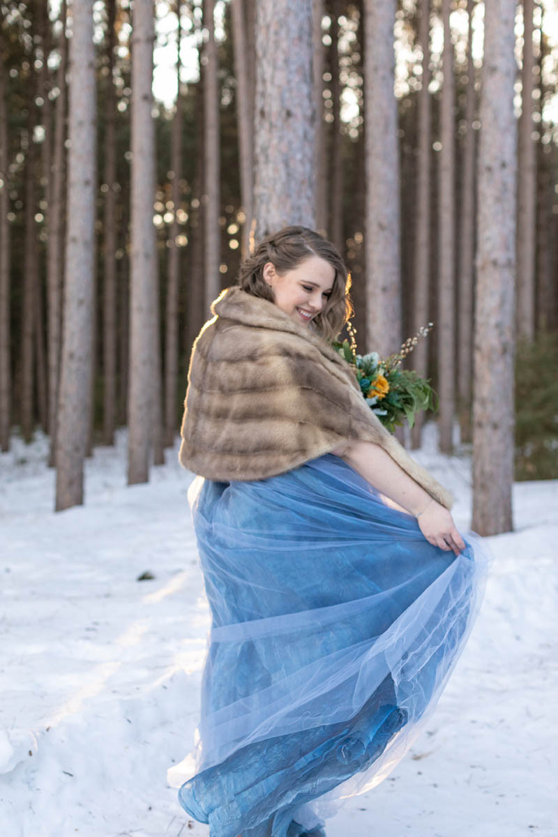 winter bride twirls in faux fir shawl