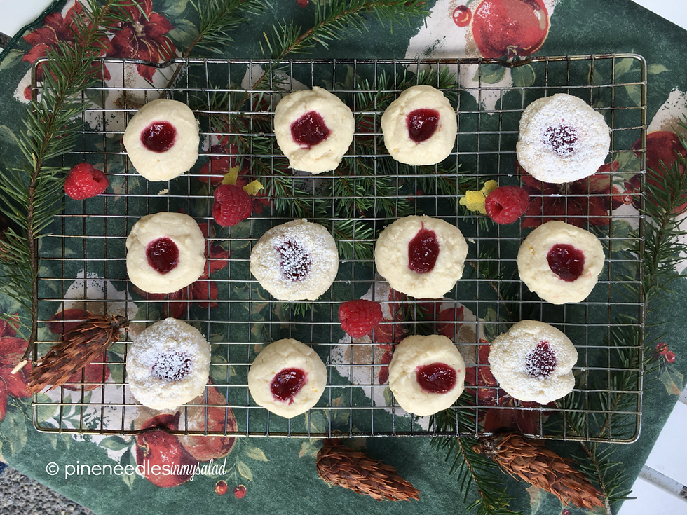 Raspberry lemon thumbprint cookies cooling on a rack.