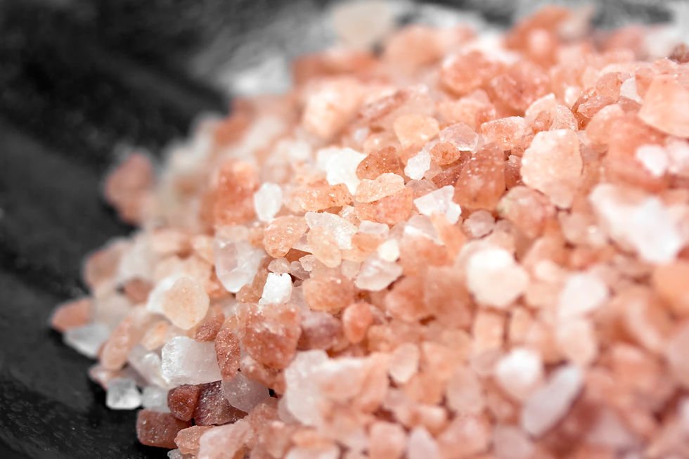 Close-up of pink and white salt crystals in a small pile