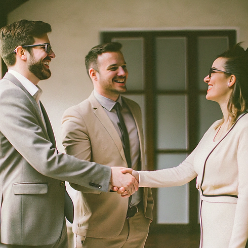 happy-businessmen-and-woman-shaking-hands.png