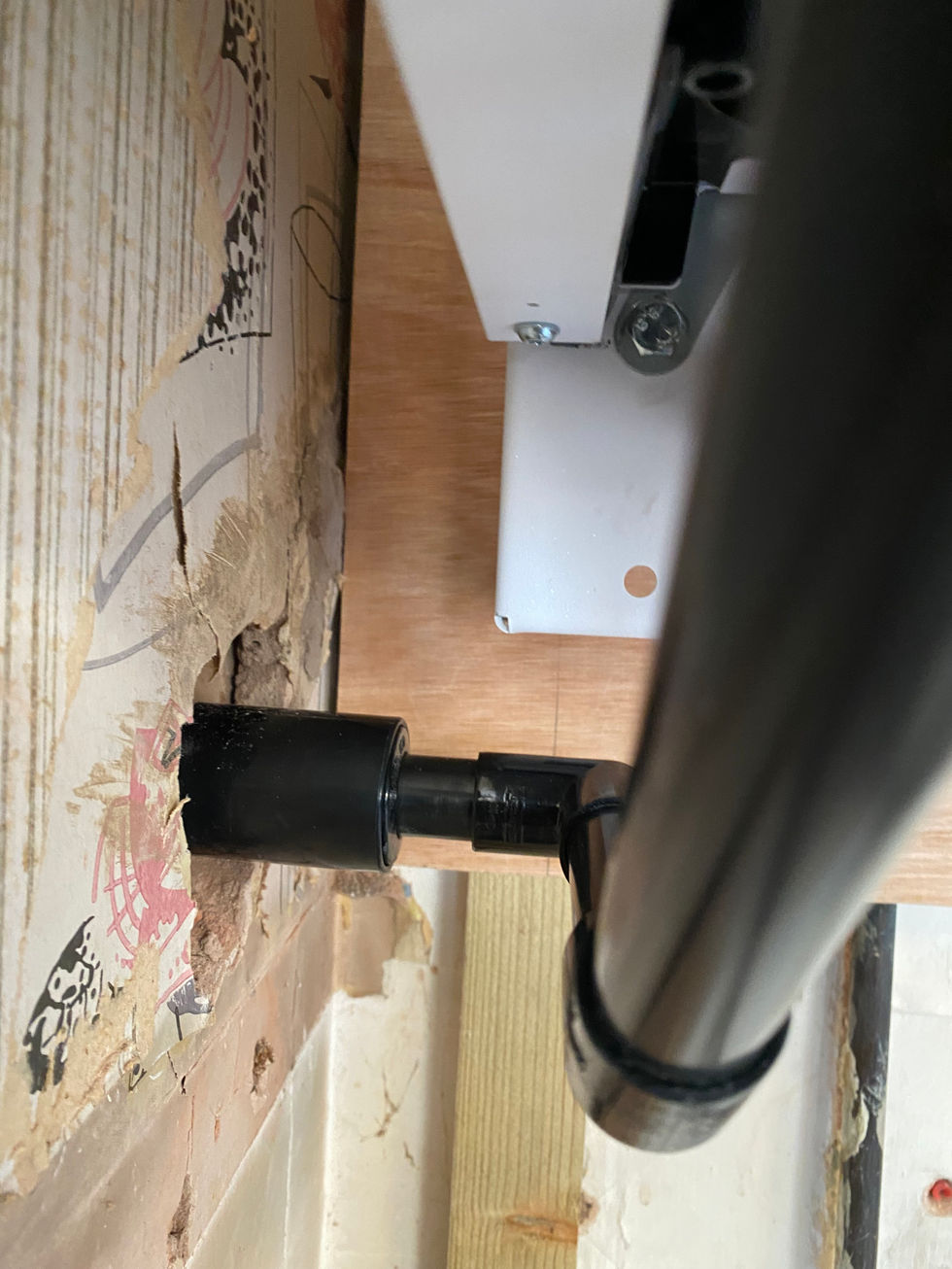 a hole in a wall with a screw in it
