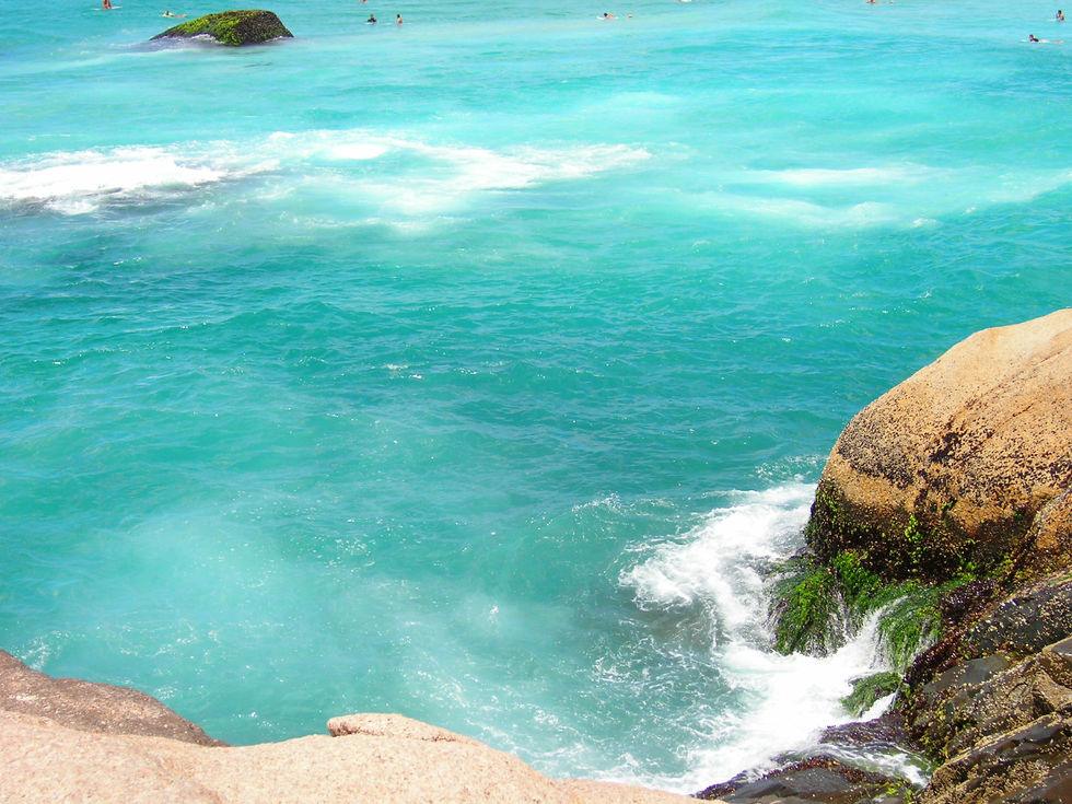 The sea, in a shade of liquid crystal, caresses the rocks with soft, white foam. The water kisses the cliff, leaving an ephemeral veil before returning to the deep blue. It is a moment of strength and delicacy, of silence and sound, eternalized by the sunlight.