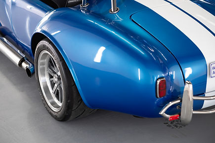 close up of Ceramic Coating on glossy ford cobra in the studio workshop 