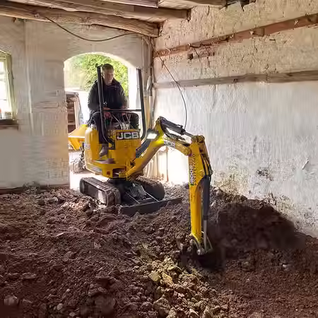Mini Digger within Barn digging out