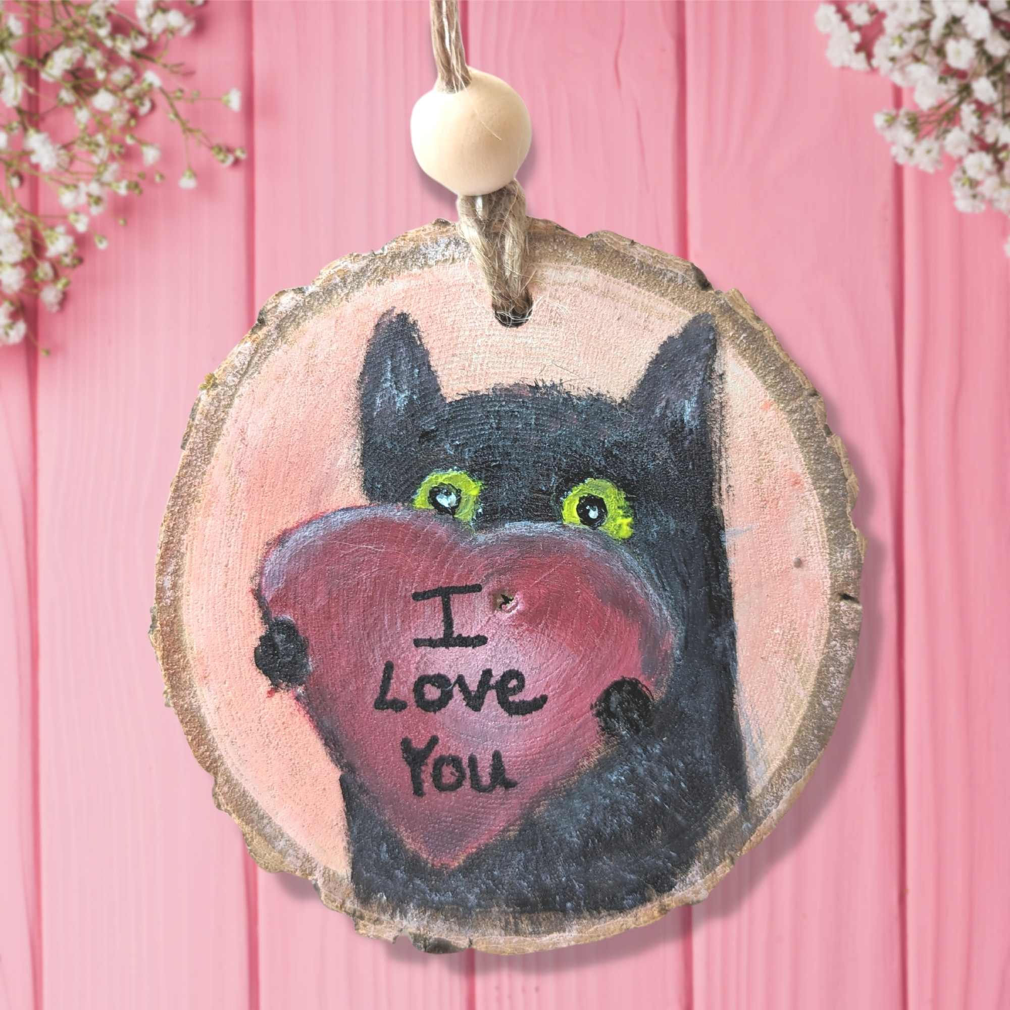 black cat holding a red heart with the words I love you