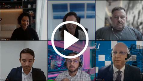 Six people on a video call, each in separate frames, some with headsets. Backgrounds vary, and a play button is overlaid on the image.