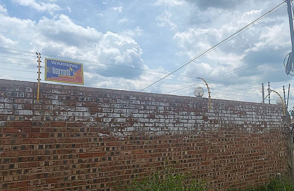Electric fence on a brick wall, Barrett Electronics Products