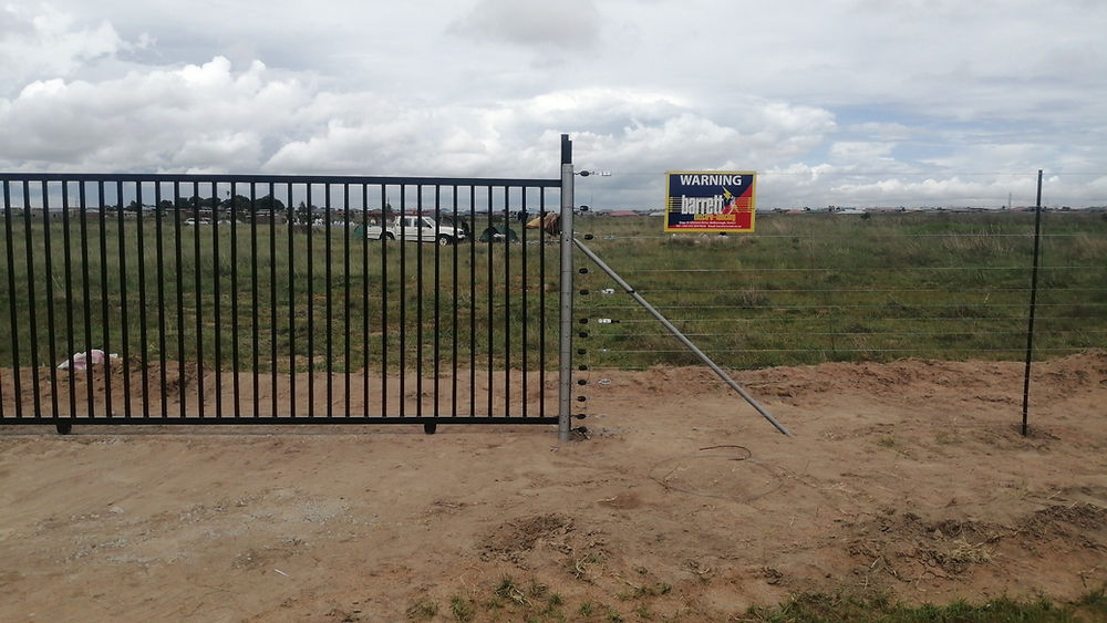 Black metal gate and fence by Barrett Electronics Products